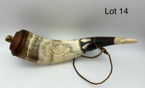 Carved Powder Horn with Ram Relief: A hand carved powder horn featuring a detailed relief of a bighorn sheep, additional leaf/floral motifs about the tip. Antler plug, leather strap, measures 11 1/2" x 6" x 3"