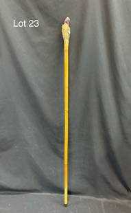 Vintage Carved Parrot Cane: A vintage bamboo cane adorned with a brightly painted hand carved Macaw, glass bead eyes. Metal cap, measures 40" long.