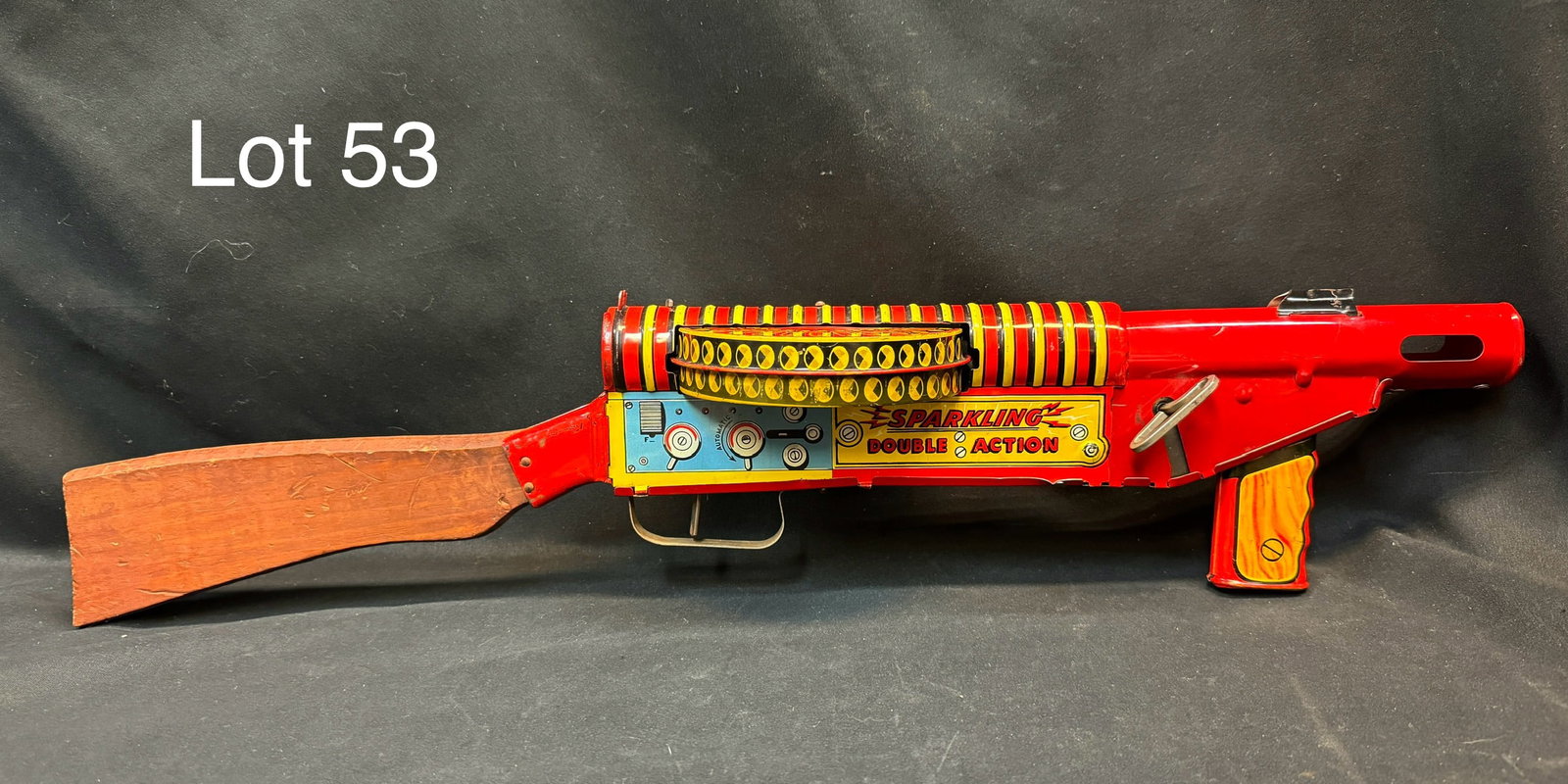 Louis Marx Co. Double Action Tin Litho FBI G-Man Sparkling Toy Machine Gun: A Marx G-Man tin windup double action machine gun toy circa 1930's. Features a wind-up mechanism that allows it to move and make realistic gun sounds. With wooden stock and decorated with tin litho 'G