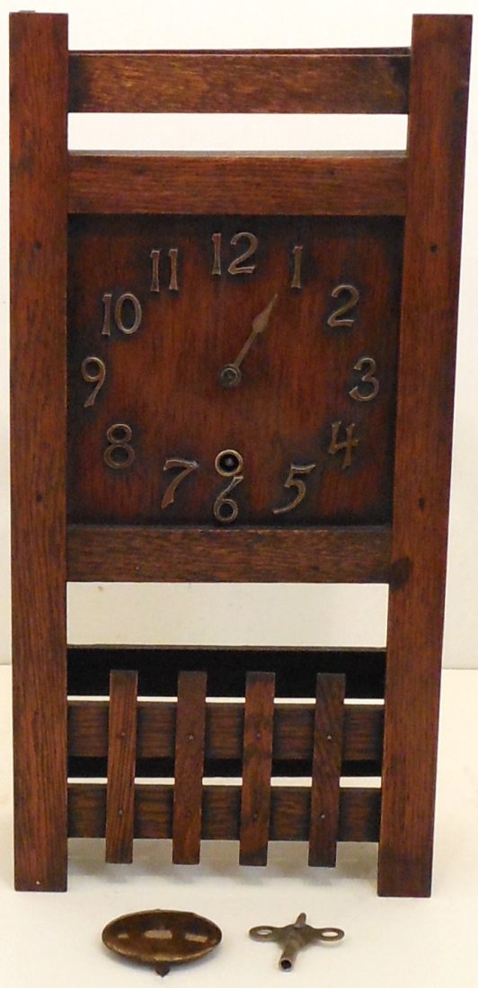 Sessions Mission Shelf Clock: 17" tall X 8 1/8" wide X 4 1/4" deep, believed to be a Sessions oak mission style clock, missing minute hand, missing one side slat, partial paper label, working condition at time of cataloging not gu
