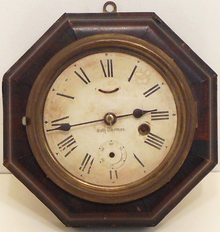 Seth Thomas Rosewood Lever Clock: 8 3/4" diameter with a 5 1/2" face, Seth Thomas 8 Day Octagon Rosewood Lever Clock, partial label on back, rosewood case has some veneer loss, cracking and fading, dial has loss and browning, missing