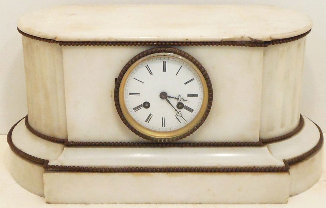 Alabaster French Mantel Clock: 8 1/4" tall X 17" wide X 8" deep, cream colored alabaster French clock, time and strike, face is crisp, case has some cracks, chips and discoloring, missing rear door. Working condition at time of cat