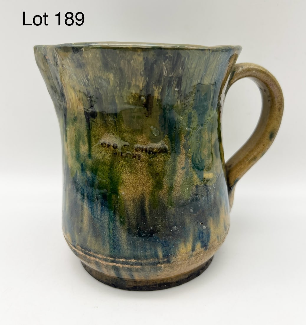 George Ohr (1857 - 1918) Pottery Pitcher: George Ohr, "The Mad Potter of Biloxi". Here we have one of his pieces, though repaired, still a wonderful work of the potter's art. A pitcher In green and neutral tones with applied strap handle. Cle