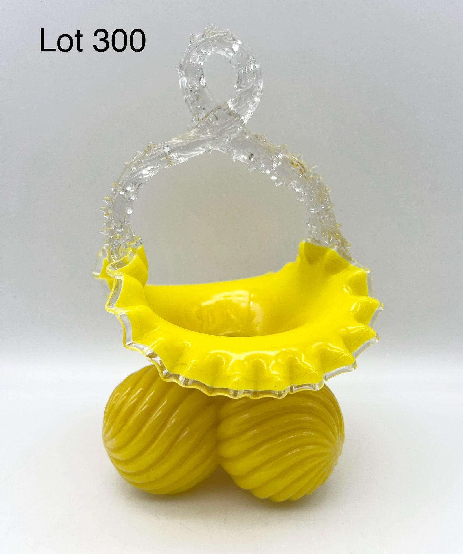 Antique Czech Art Glass Basket With Ball Base and Thorned Handle: A 19th century Czech yellow art glass basket with clear glass thorned handle, ruffled rim and three balled base. 9" tall.