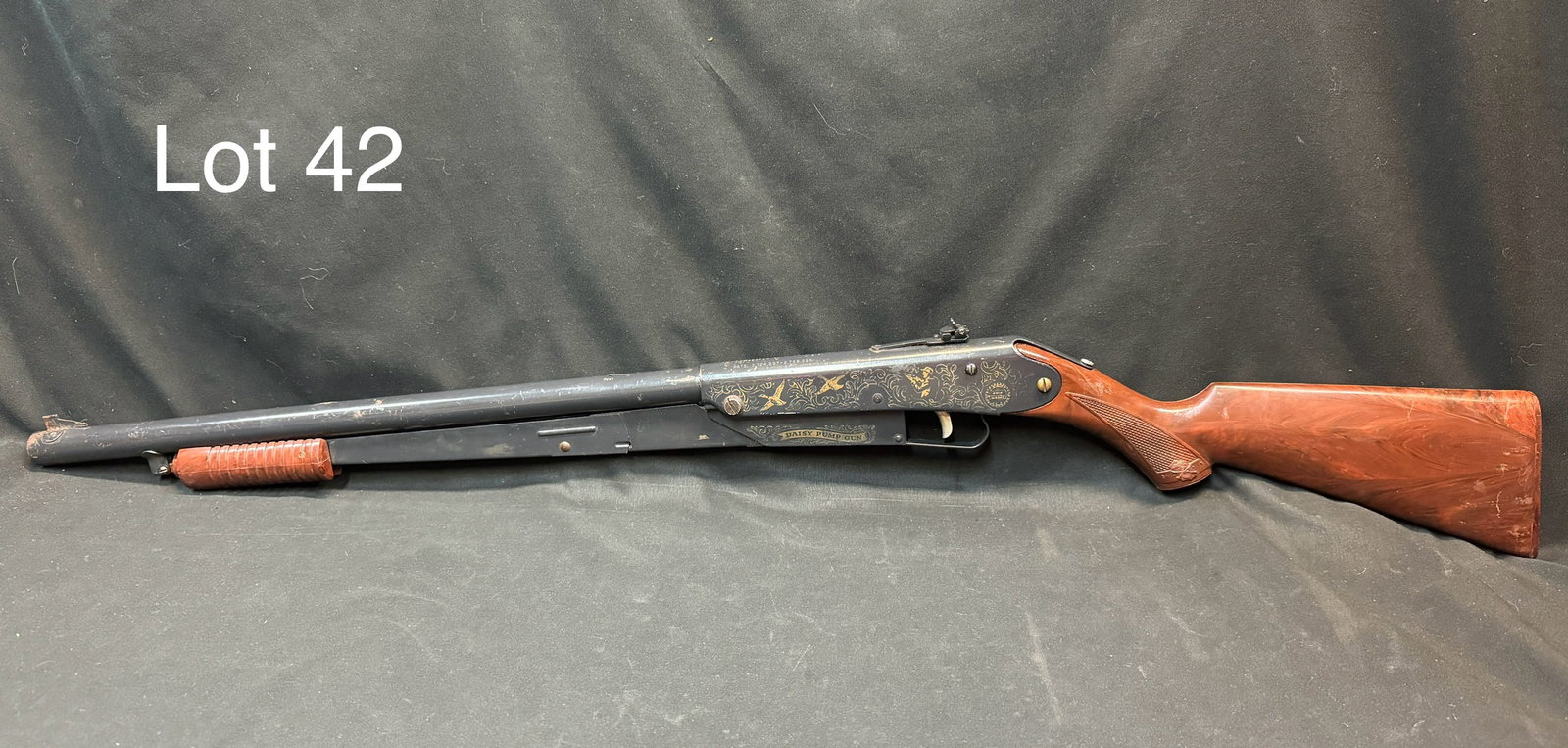 Daisy Model 25 Cork Rifle: A vintage Daisy Model 25 pump action cork gun. Hunting scene on either side, provided with corks, measures 36 1/2". *note - some scratches and wear
