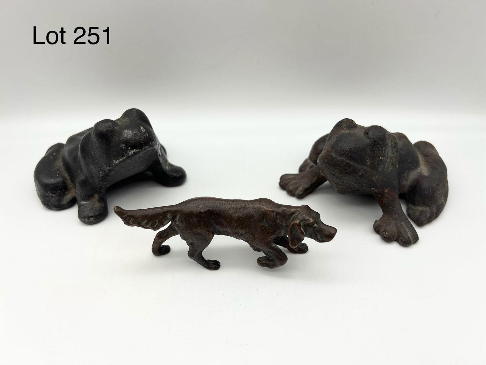 Jennings Bros. Bronze Retriever Together with Two Vintage Cast Iron Frog Doorstops: This lot is a Jennings Bros. bronze retriever, marked "JB 2893" under tail. Measures
