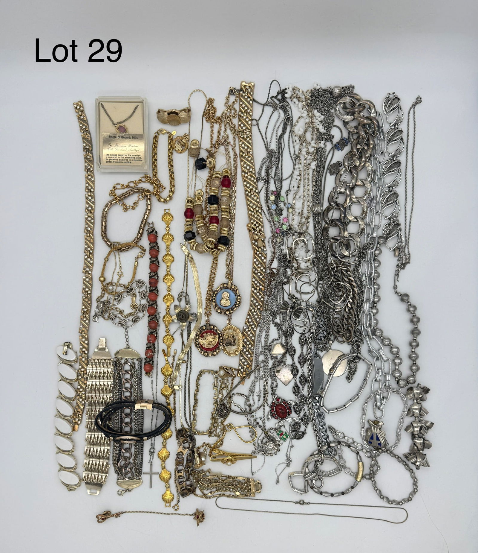 Costume Jewelry Lot in Silver & Gold Tones: A nice lot of costume jewelry in silver & gold tones featuring pendant necklaces, chain bracelets, colorful faux stones, and more.