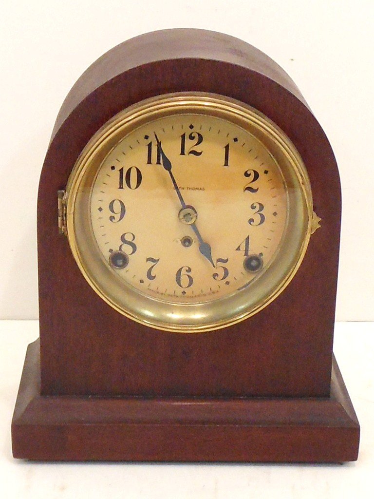 Seth Thomas Beehive Mantel Clock: 9 3/4" tall X 8 1/4" wide X 4 7/8" deep, Seth Thomas time and strike with half hour strike, circa early 1900's, Mahogany case has checking, dial has browning, repair label on back dated 1992. Working