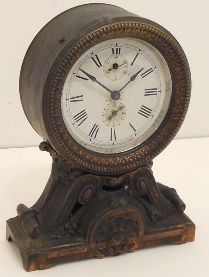 Seth Thomas 'Long Alarm' Mantle Clock: 9" tall X 7" wide X 3" deep with a 4" diameter face, circa 1886, metal case with heavy patina has a few dings and tarnish, face has minor browning, working condition at time of cataloging not guarante