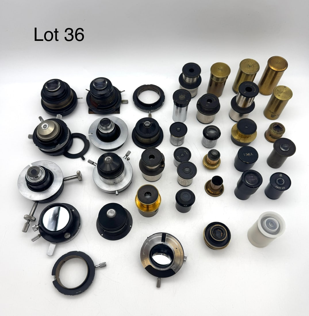 Box of Vintage Microscope Condensers Eyepieces and Objective Lenses: A box of vintage microscope eyepieces, condensers and objective lenses including Zeiss Jena.