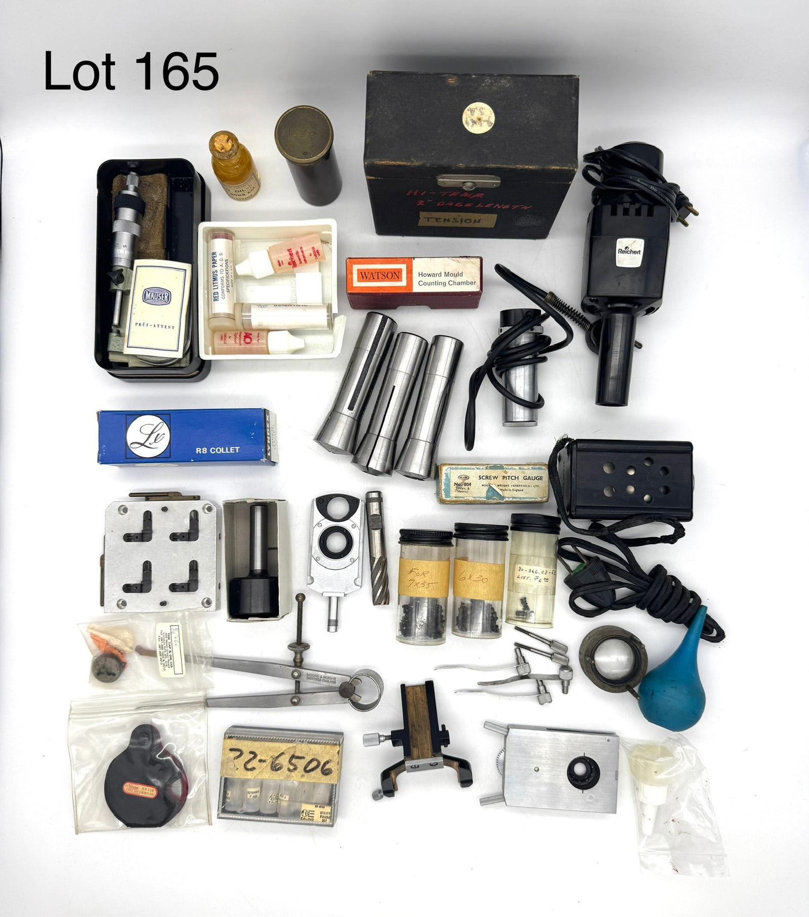 Box Of Vintage Assorted Microscope Parts and Accessories By Watson, Zeiss Jena, and Spencer and More: Box of assorted vintage microscope parts and accessories that include vial of Watson Immersion Oil, Zeiss Jena vial of Cedar Oil, empty specimen slides, litmus paper, Mauser micrometer head, and much