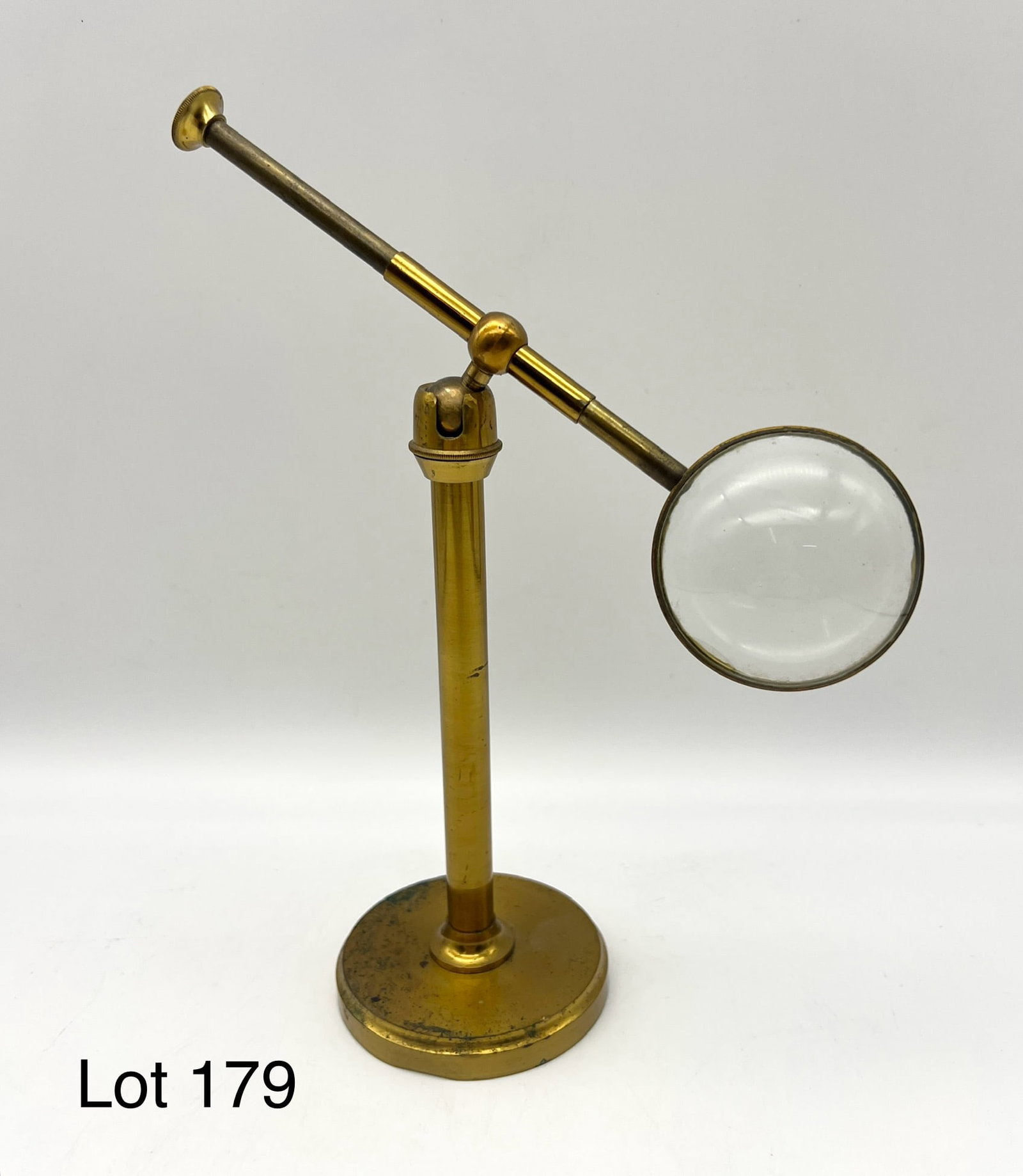 Small Antique Adjustable Brass Magnifier On Stand: Small antique adjustable brass magnifier on stand. Cosmetic wear.