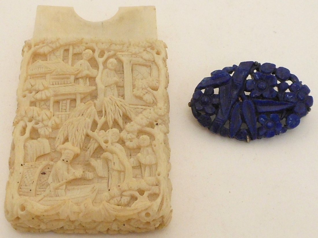 Hand Carved Ivory Like Card Holder and Lapis Pin: Lot of two. 3" X 1 1/2" X 1/2", Chinese, carved card holder decorated with landscape scenes with people tress and buildings, missing lid. 1 14/" oval pin believed to be lapis, hand carved and decorate