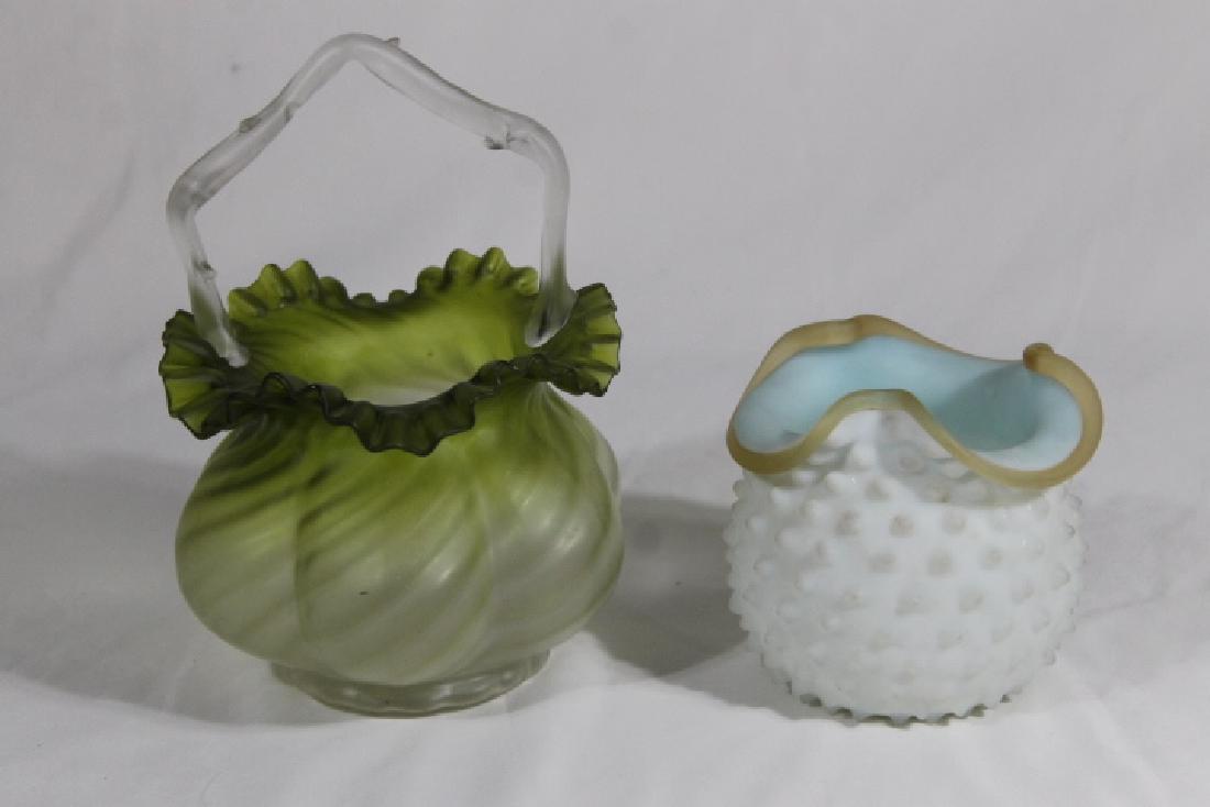 2 Pcs of Mt Washington Glass: 1. Brides basket green to clear 8" tall swirl base with ruffled rim and thorned handle 2. Milk glass w/blue interior and gold rim. 4 1/2" tall