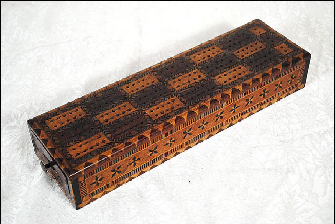 Inlaid Cribbage Board: Cribbage board with pins and 2 decks of cards. Board is heavily inlaid as well as sides of draw. Size is 14" x 4" x 2 1/4"