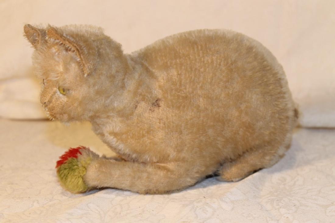 Early 1900's Steiff Cat w/Wool Ball: Early 1900's cat made by steiff, has ear tag in right ear, size is 8 1/2" long, [not including the tail], button eyes