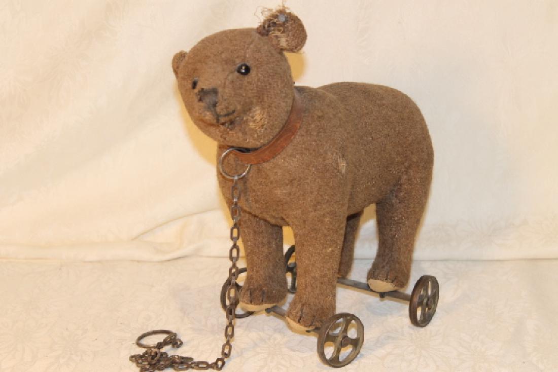 Circa 1900 Steiff Bear Pull Toy: Early steiff bear pull toy, on cast iron wheels. Stitched nose and button eyes, felt pads, has ear tag, all original, size is 10 1/2 by 11 1/2" long