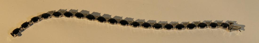 A tennis bracelet by Bucherer, 14 kt white gold set: A tennis bracelet by Bucherer, 14 kt white gold set with 20 diamond and 20 saphires, size is 7"