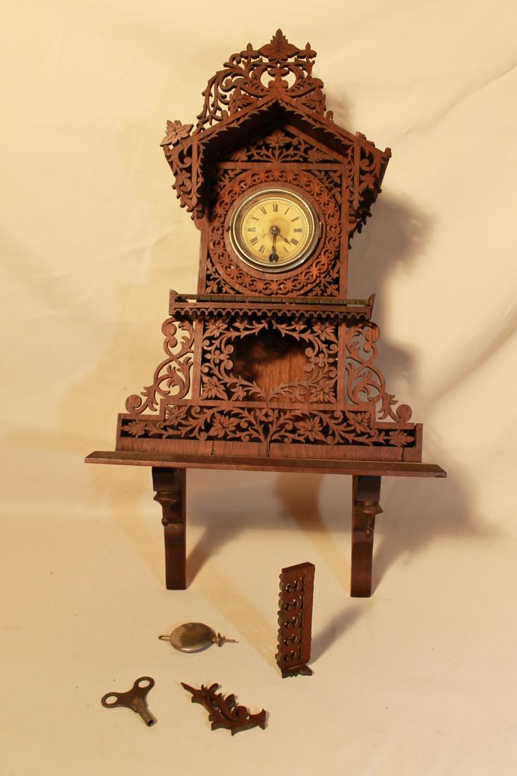 Wall Clock, with Elaborate Fretwork: Wall clock with floral cut outs, maker unknown, size is 22 1/2" x 13" wide