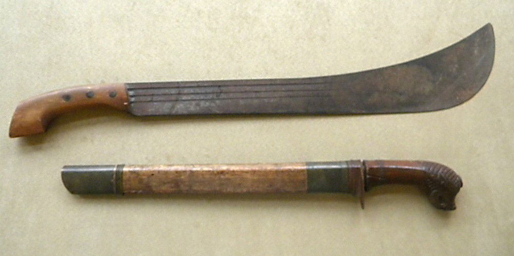 Lot of 2 machetes: Lot of 2 machetes. One is 20.5", signed Tjipatjing, dated 1918. The other is 26.5", plain.