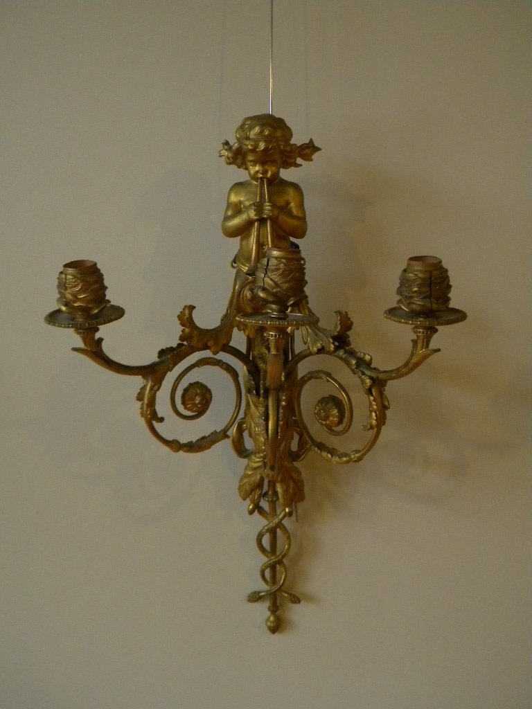 Gilt Metal Child w/ Horn wall sconce: Gilt metal 3 arm sconce, 25 1/2" long, scrolling arms depicting child with horn, heavy gilt on metal