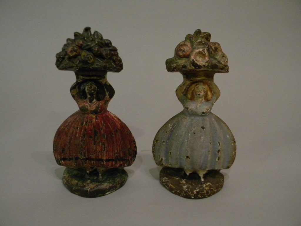 2 Doorstops: Both female figures, one with basket of flowers, one with basket of fruit, both approximately 9 inches tall,