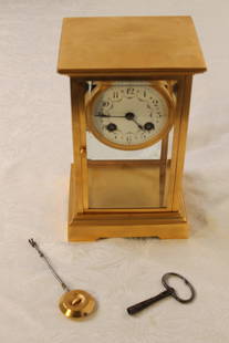 Tiffany & Co Mantle Clock: Tiffany & Co Mantle Clock French mantle clock brass case, with bevelled glass, porcelain dial w/garland decoration, marked France, rear clockworks stamped Tiffany & Co France size, 4 1/2" x 5 1/4" x 8