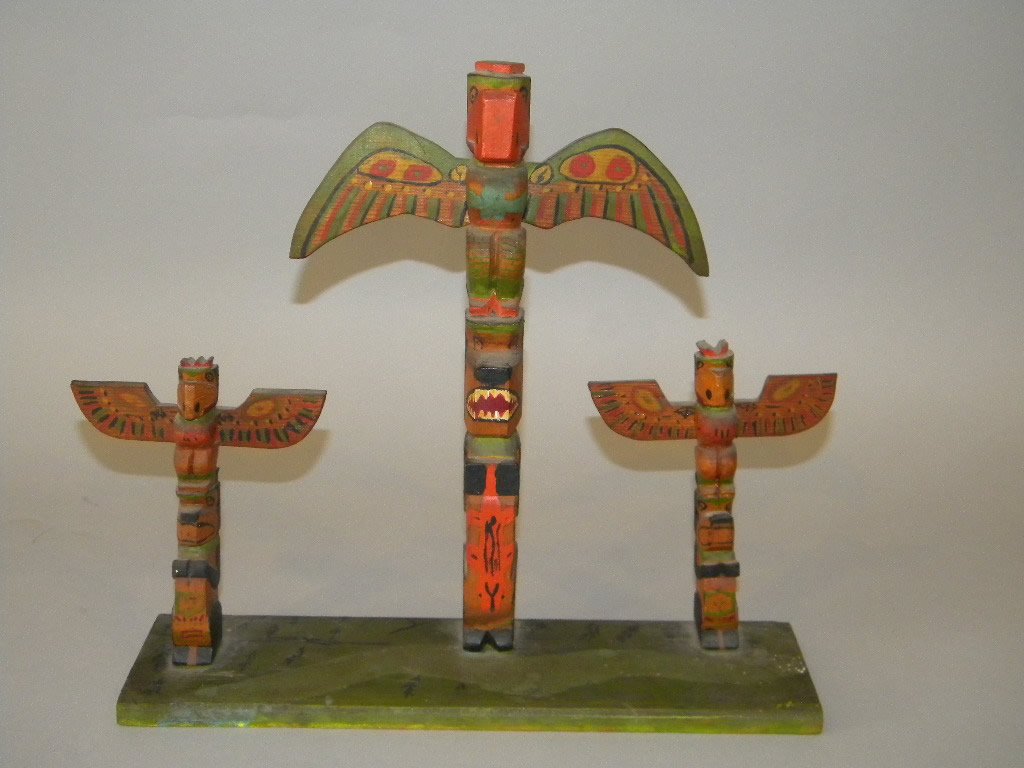 Billy Samson Triple totem on stand: Height is 12 1/4" tall by 13" wide base, 3 carvings mounted on base. "Done by Billy Samson Kanaka Bar Lytton B.C. under base