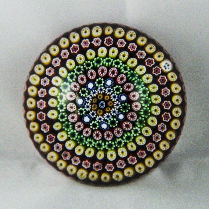 Baccarat, Modern 1982 Paperweight: Modern Baccarat 1982 paperweight. Cane 1, millifiori, concentric. Concentric millifiori, red, tan, green. DW: 82.2 HW: 57.2 W: 692.5