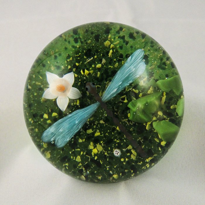 Baccarat, Modern 1982 Paperweight: Modern Baccarat 1982 paperweight. Cane 1, lampwork, insect, dragon fly. Libellule Bleue (#18427). Blue dragonfly, pale blue wings, white water lily floating on green and yellow pebbled ground. DW: 82.