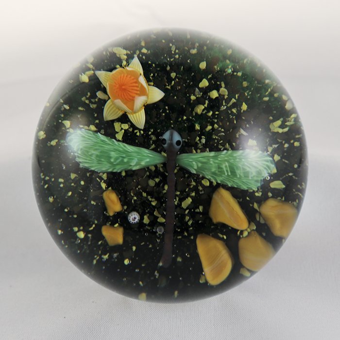 Baccarat, Modern 1982 Paperweight: Modern Baccarat 1982 paperweight. Cane 1, lampwork, insect, dragon fly. Dragon fly, green wings, yellow water lily budding out of damp green and yellow pebbled soil. DW: 81, HW: 62, W: 708.3.