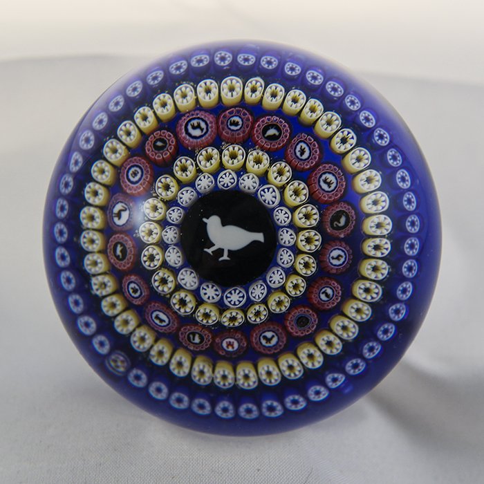 Baccarat, Modern 1979 Paperweight: Modern Baccarat 1979 paperweight. Cane 1, millifiori, gridel, pigeon. Bird (Pigeon) Gridel, transluscent blue ground, 5 concentric rings - middle ring with 18 silhouette canes. DW: 77.2, HW: 53.8, W: 