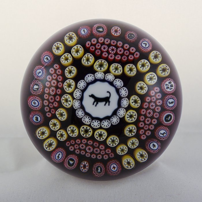 Baccarat, Modern 1978 Paperweight: Modern Baccarat 1978 paperweight. Cane 1, millifiori, gridel, dog. Dog gridel, 4 quadrants of yellow and red patterned millifiori, ring of 17 gridel silhouettes. DW: 78.6, HW: 56, W: 625.1