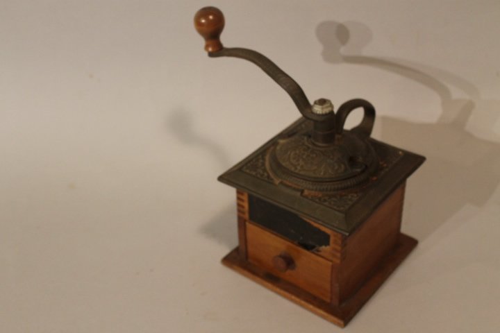 281. Colonial Coffee Grinder: Square box coffee grinder with partial Colonial label. 6 inches square, hand crank with draw
