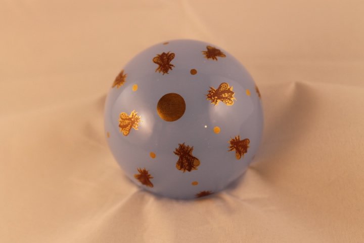 Baccarat Paperweight, undated: Baccarat paperweight. Cane 2, opaline, insect. Light blue opaline with 12 painted gold bugs. Size is 2 3/4" wide by 1 3/4" tall
