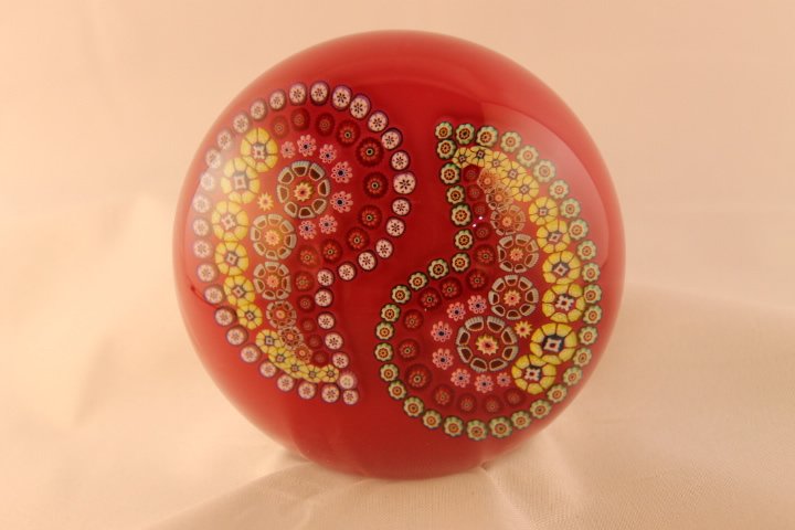 Baccarat, Modern 1998 Paperweight: Modern Baccarat 1998 paperweight. Cane 1, millifiori, patterned, garlands. "Cashmere" Patterned Millifiori with 2 loops of complex canes on red ground. Size is 3 1/4" wide by 2" tall, has box