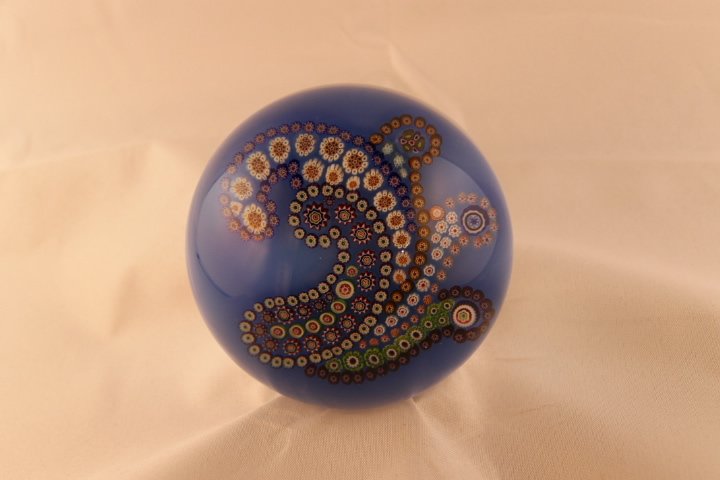 Baccarat, Modern 1998 Paperweight: Modern Baccarat 1998 paperweight. Cane 1, millifiori, patterned, complex garland. "Cashemere" Patterned Millifiori with 1 complex loop of complex canes on blue ground. Size is 3 1/4" wide by 2" tall, 