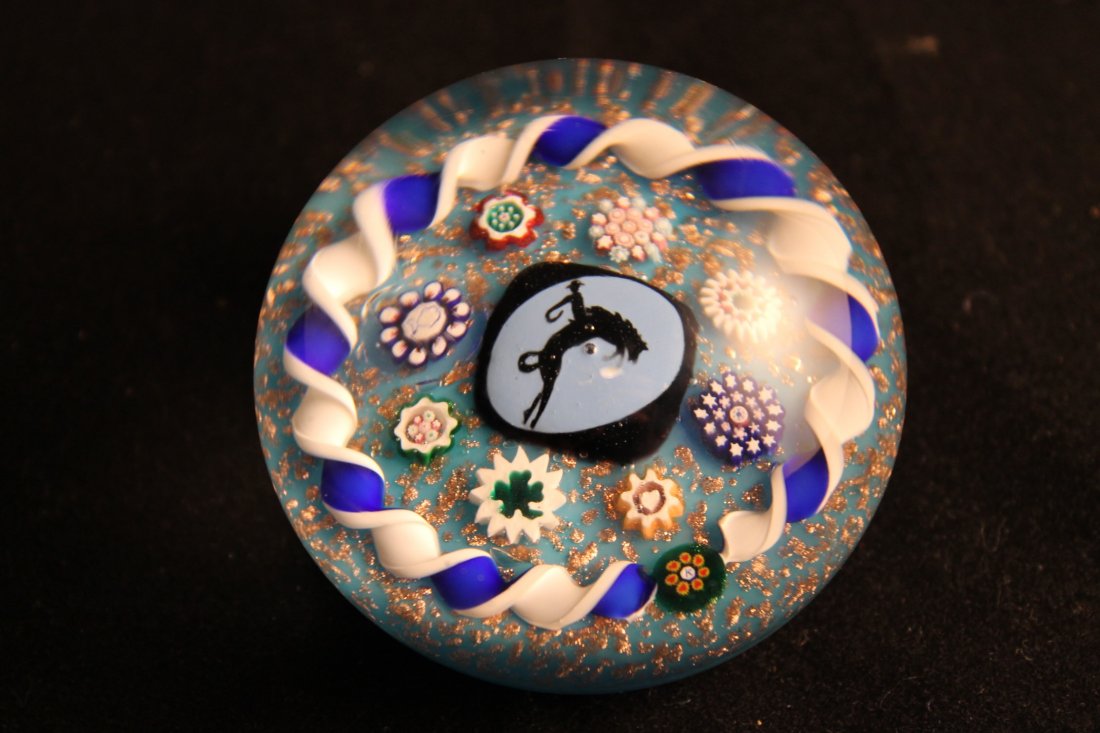 Charles Kaziun Jr Paperweight: Black central silhouette cane of bronco buster, on blue background, 8 complex canes, torsad blue and white early 1950's signature cane on blue gold and stone ground, size is 2 3/8"