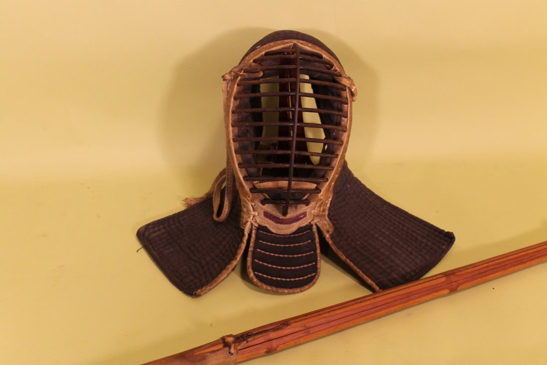 16th 18th Japanese Kendo Mask & Shinai: Japanese Kendo Mask and Shinai, metal face mask with leather trim and cloth guards, Japanese characters on side of cloth, Early stick, size is 45 1/2" long and mask is 16" length overall.