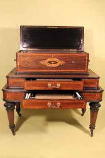 B.A. Bremond Music Box and Cabinet: Circa mid to late 19th Century B.a. Bremond music box with original cabinet base, walnut or rosewood with tulip wood and mother of pearl inset. 10 interchangeable rolls held in two draws. Overall heig