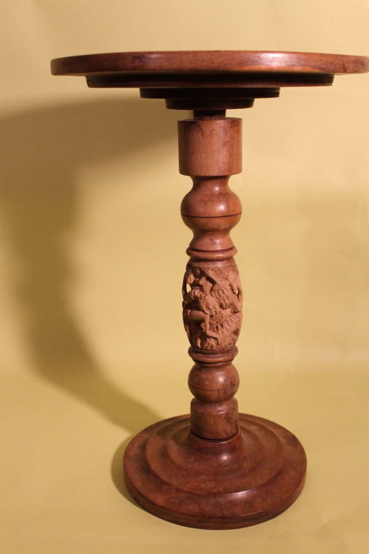 African Tea Table: Disc top table with carved post of figures and fruit. Size is 20" tall by 13 3/4" diameter. From the Albert Neill estate, Saxtons River