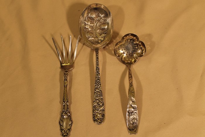 3 Pcs of Sterling Silver: 1. Jacob & Jenkins strawberry spoon, floral repousee handle, punched strawberry bowl, length is 8 1/2" 2. Pierced ladle, Shreve Crump & Low size is 6 5/8" strawberry design to handle 3. Potato fork, G