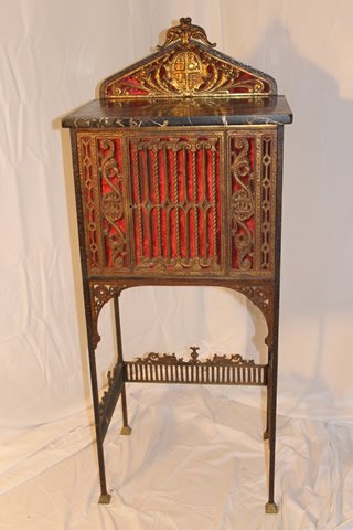 Gothic Marble Top Telephone Stand: Gothic black marble top iron telephone stand with velvet backing, embelished with a crest, phone sets inside with wire door out the back and door on front. Height is 49", x 18 1/2" width, by 13" deep