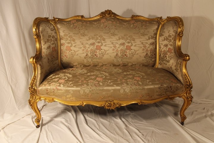 Carved & Gilded French Loveseat: French carved and gilded love seat with high back and cabriole legs, with fine silk upholstery. 41 1/2" high to top of back, 24" deep, 56" wide, and a 19" height to dest