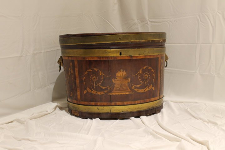 English Cellarette: English oval cellarette, with satinwood inlay of foliate swags, top inlaid with urn and cupids, mahogany primary wood, size is 18" tall by 24" long x 17 1/2" wide