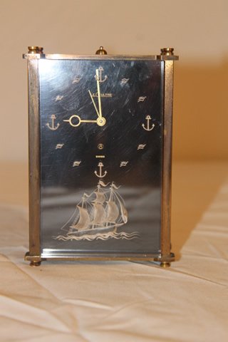 LeCoultre Swiss 8 day Desk Clock: Oblong desk clock, 8 day by LeCoultre, Swiss, model # 2163 engraved white ship on lucite inscribed to Dr. Henry S. Finkel, size is 5" tall by 3 1/4" wide
