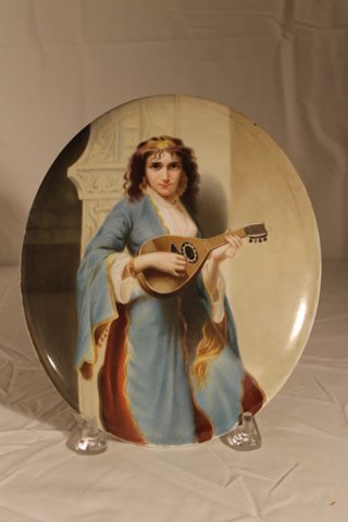 Oval KPM Porcelain Plaque: Oval hand painted porcelain plaque with impressed KPM mark, and F-5. Girl with Mandolin, size is 10 1/2" x 8 3/4"