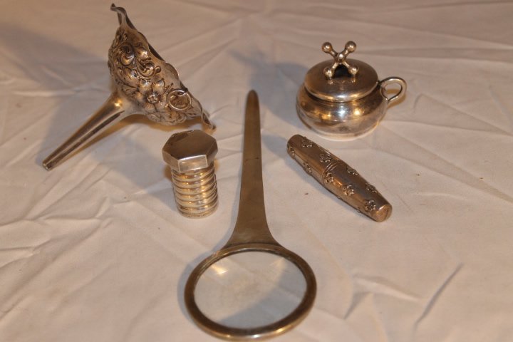 Five Pcs of Sterling: 1. Tiffany nut and bolt pill box, 1 3/8" tall 2. Repousee , 3 1/8" long 3. "Jacks" lighter, 1 5/8" 4. Fleur D'Lys travling cork screw, 2 1/2" 5. Magnifier/letter opener 7" total weight is 5.78 ozt inc