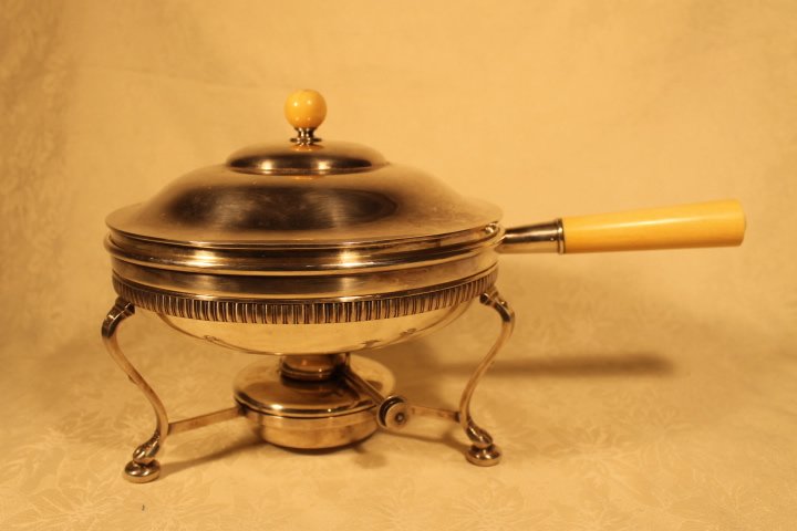 Tiffany & Co. Silverplated Chafing Dish: Tiffany & Co silverplated chafing dish. 9" x 2" deep chafing dish with bone handle, cover has a bone handle. Burner holder sits 4 1/2" high x 9" diameter with claw feet. Holds 1 pint.