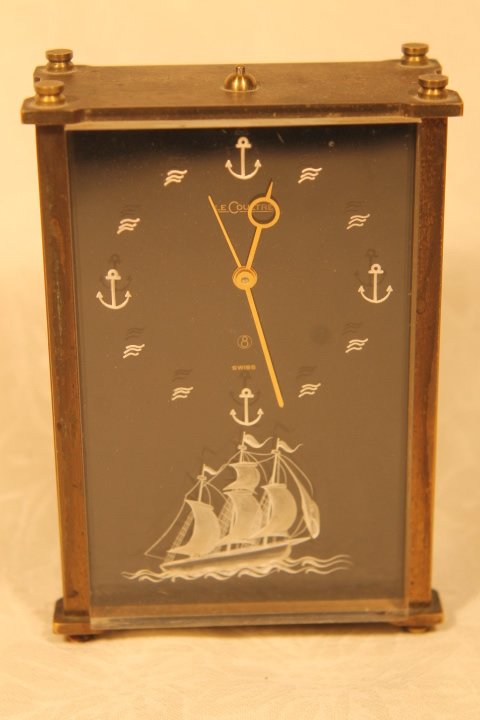 Le Coultre Table Clock: LeCoultre Table Clock, 5"t x 3 1/4" w, oblong. Nautical symbols on face of clock with a white ship in bottom center. Clock has a lucite front and is monogrammed "Dr. Henry S. Finkel" Model No. 2163